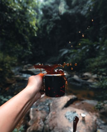 coffee-in-black-cup-camping-in-the-forest
